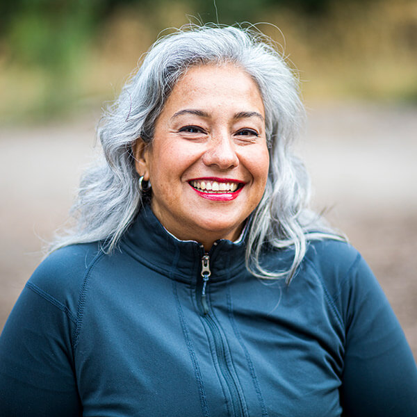 A mature woman with gray hair smiling